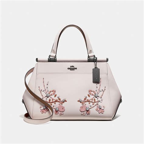 white coach bag with pink flowers